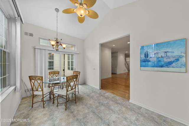 dining area featuring ceiling fan with notable chandelier and high vaulted ceiling