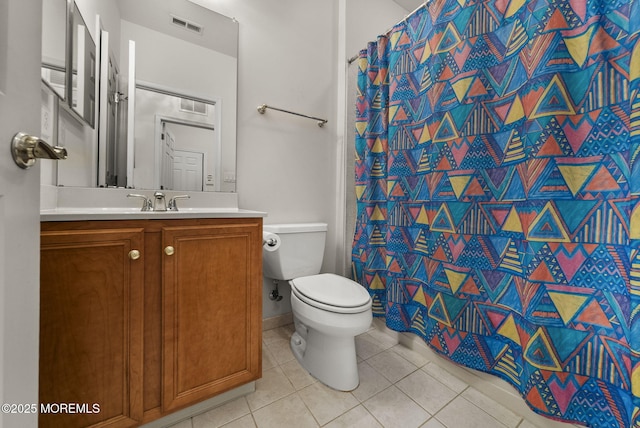 bathroom featuring a shower with shower curtain, vanity, toilet, and tile patterned floors