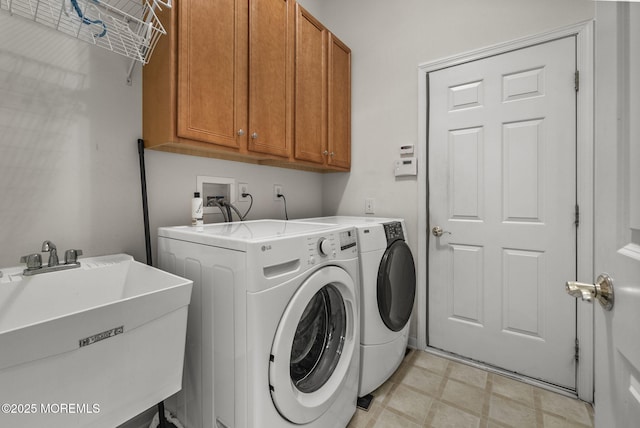 clothes washing area with cabinets, independent washer and dryer, and sink
