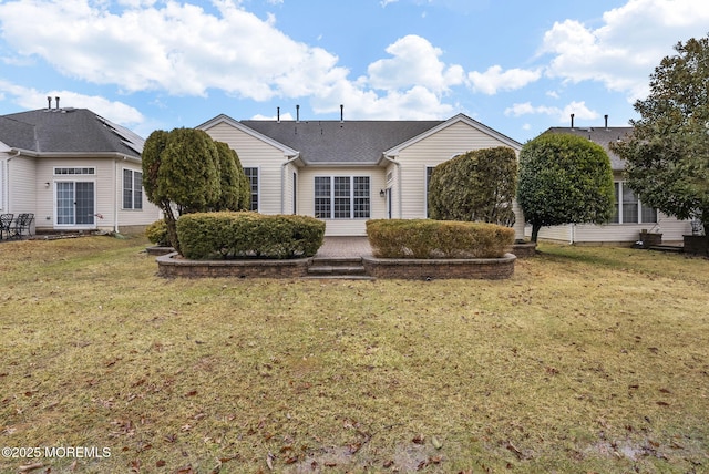 back of house featuring a yard