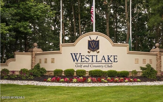 community sign featuring a lawn