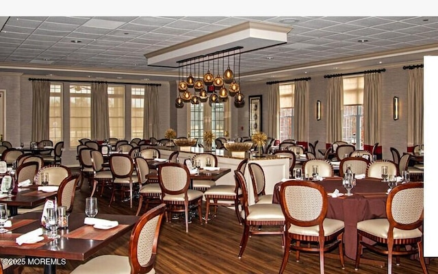 dining room featuring hardwood / wood-style floors and crown molding