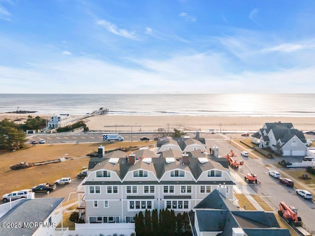 birds eye view of property with a view of the beach and a water view