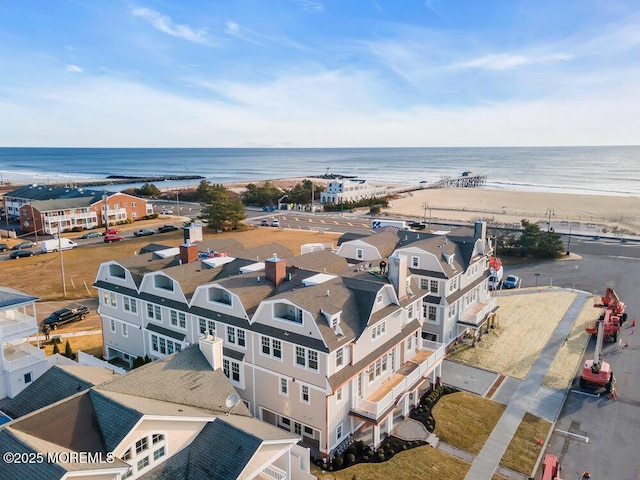 bird's eye view featuring a water view and a beach view