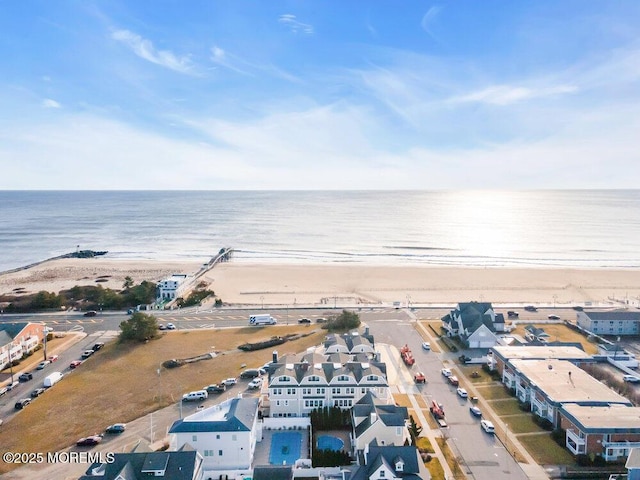 drone / aerial view featuring a view of the beach and a water view