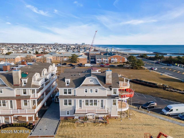 bird's eye view featuring a water view and a residential view