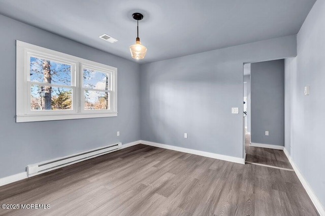 unfurnished room with hardwood / wood-style flooring and a baseboard radiator