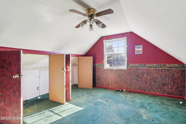 additional living space with carpet floors, vaulted ceiling, and ceiling fan