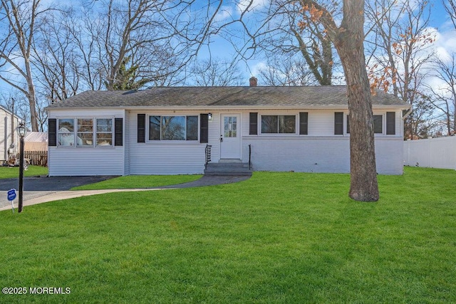 ranch-style home featuring a front yard