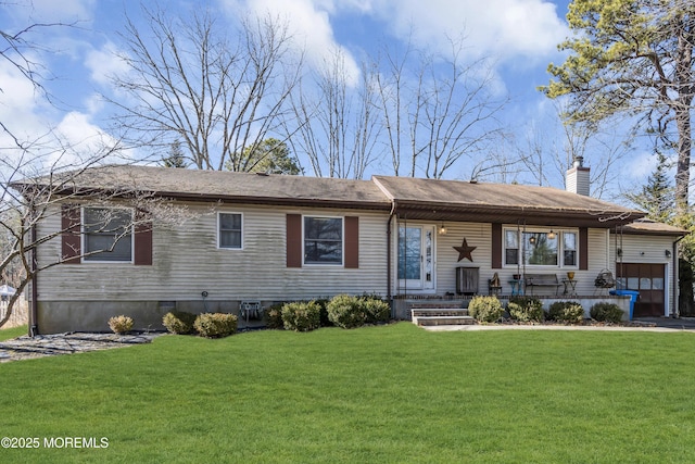 view of front of house featuring a garage, a chimney, and a front yard