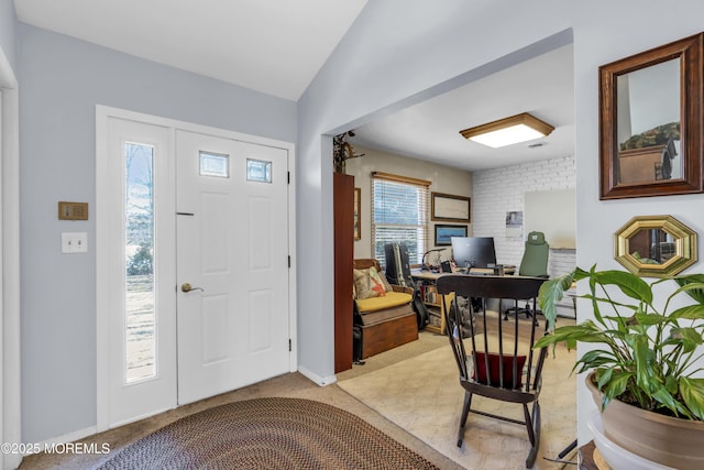 foyer with light carpet and baseboards