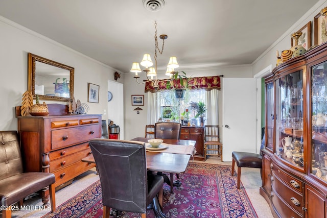 dining room featuring visible vents, a notable chandelier, and ornamental molding