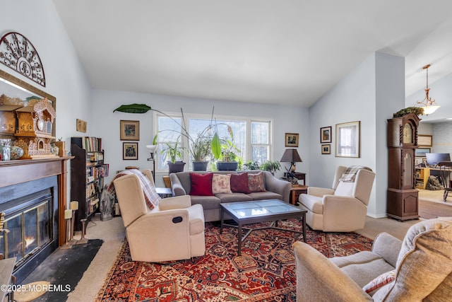 living area featuring carpet floors, vaulted ceiling, and a fireplace with flush hearth