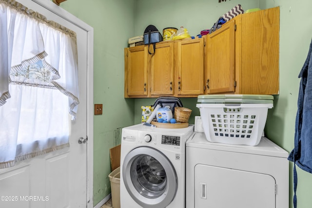 laundry room with cabinet space, plenty of natural light, and washer and clothes dryer