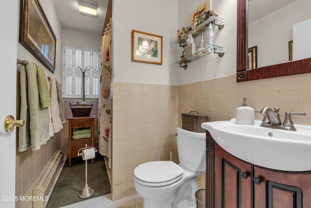 full bathroom featuring wainscoting, toilet, tile patterned floors, vanity, and tile walls