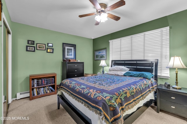 bedroom featuring light carpet, a baseboard radiator, ceiling fan, and a closet