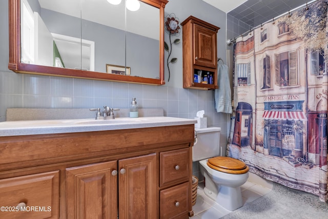 bathroom with curtained shower, vanity, toilet, and tile walls