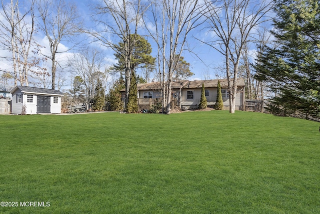 view of yard with an outbuilding and fence