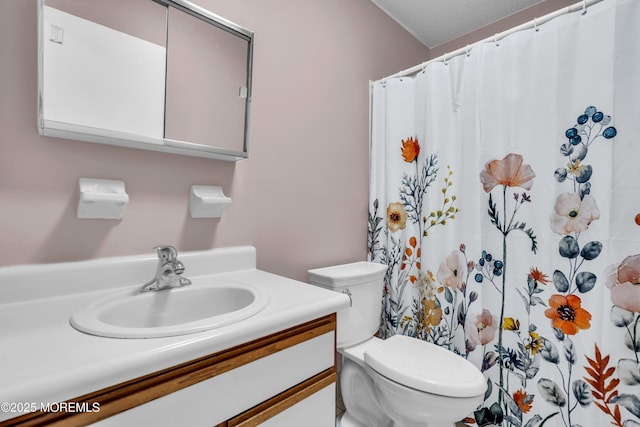 bathroom featuring vanity, toilet, and a shower with shower curtain