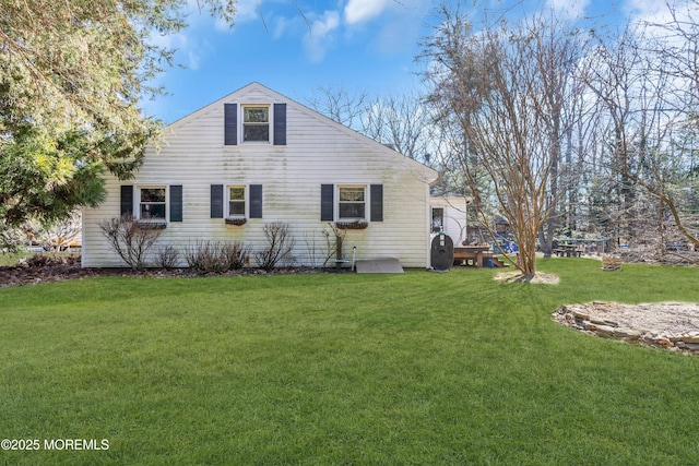 rear view of property with a lawn