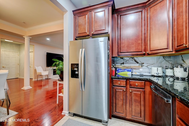 kitchen with ornate columns, tasteful backsplash, dark stone countertops, ornamental molding, and appliances with stainless steel finishes