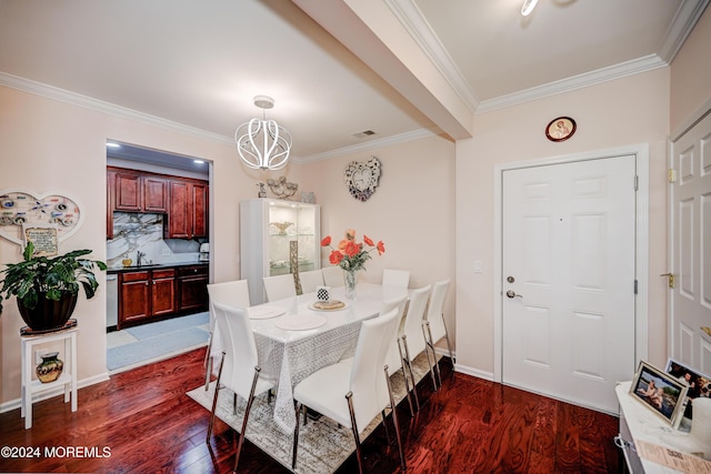 dining area with crown molding, dark hardwood / wood-style floors, sink, and a chandelier