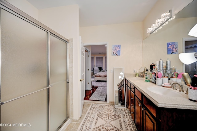 bathroom featuring vanity, tile patterned floors, and a shower with shower door