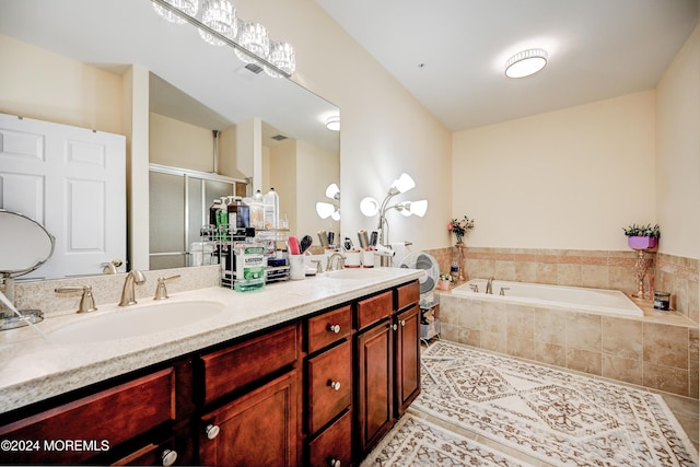 bathroom with independent shower and bath, vanity, and tile patterned floors