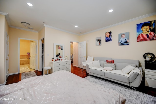 bedroom with connected bathroom, hardwood / wood-style floors, and crown molding