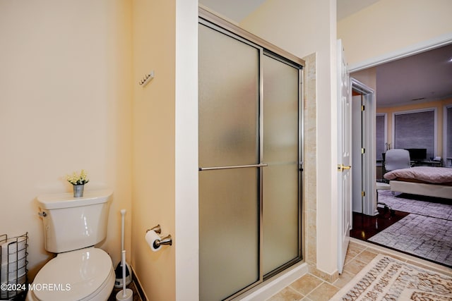 bathroom featuring an enclosed shower and toilet