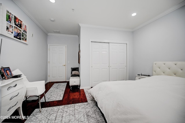 bedroom with ornamental molding and a closet