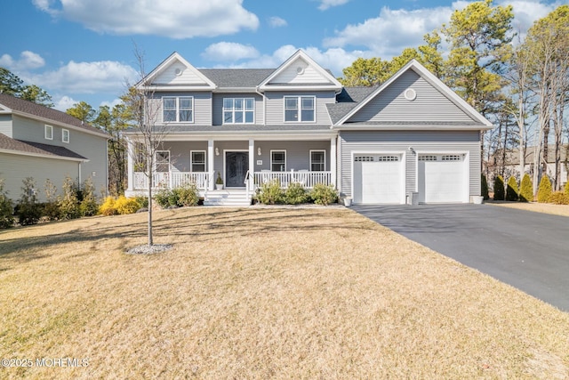 view of front of property with a garage, a porch, a front lawn, and aphalt driveway