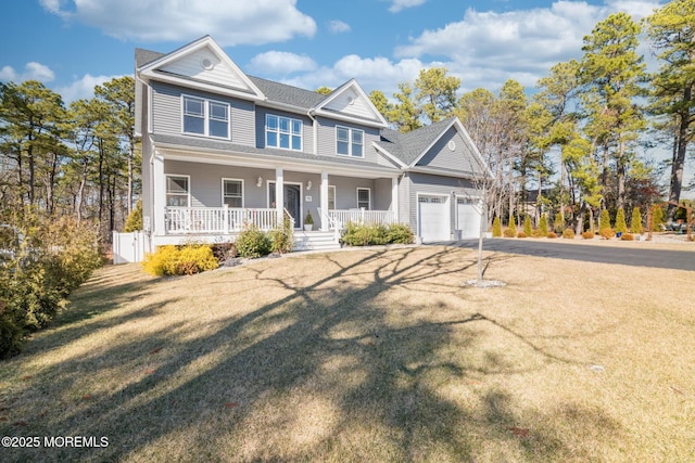 view of front of property featuring covered porch, driveway, and a front lawn