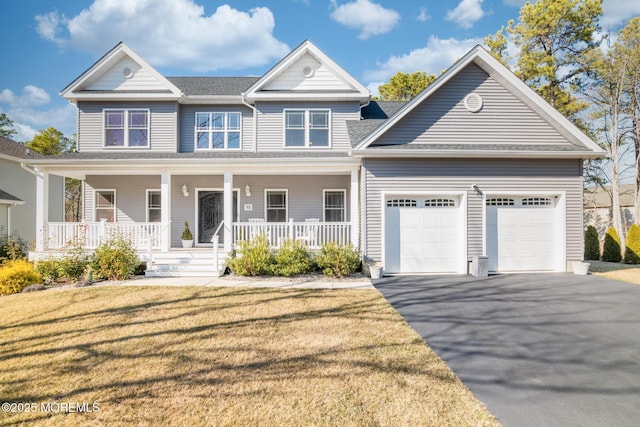 view of front of property with a porch, an attached garage, a front lawn, and aphalt driveway