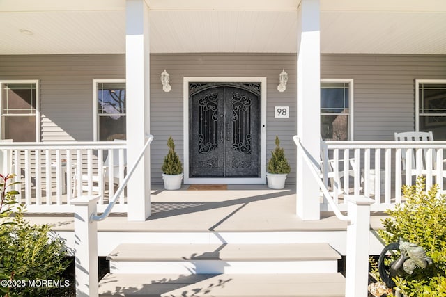 view of exterior entry with a porch