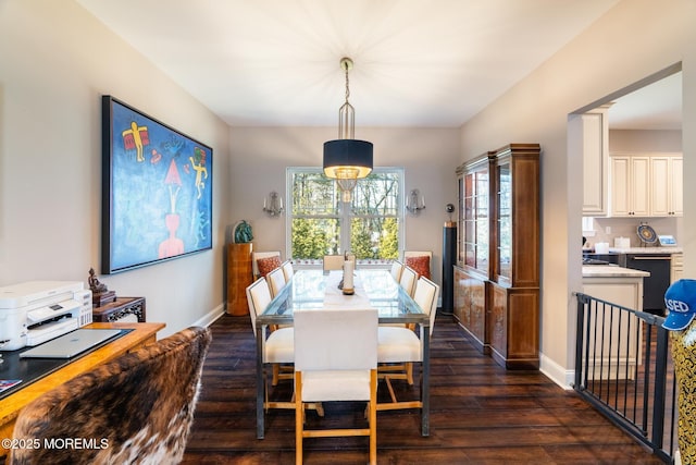 dining room with dark wood finished floors and baseboards