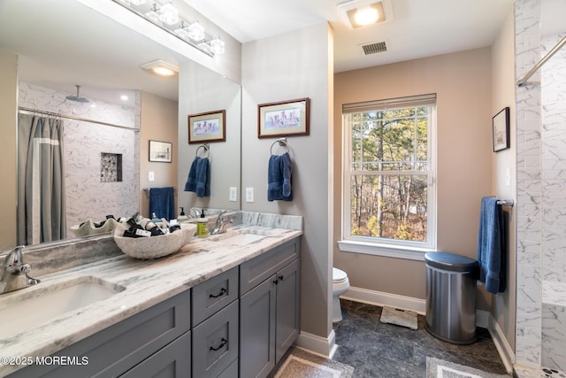 full bathroom featuring a wealth of natural light, visible vents, a sink, and toilet