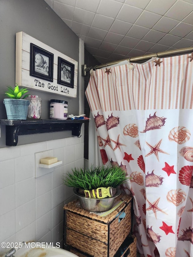 bathroom with a paneled ceiling and a shower with curtain