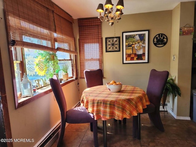 tiled dining room featuring an inviting chandelier, a baseboard radiator, and baseboards