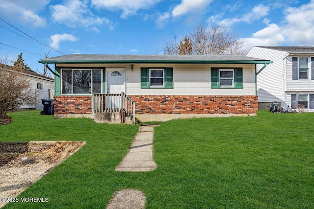 view of front of house with brick siding and a front lawn