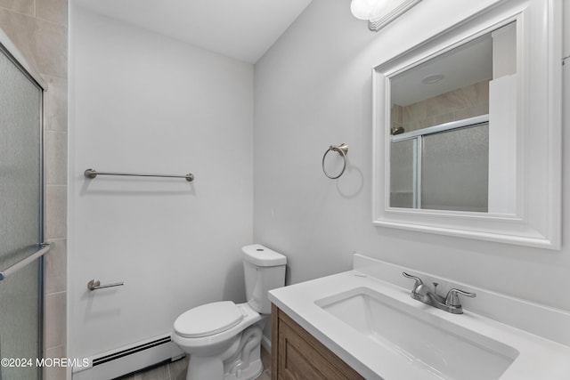 bathroom featuring a shower with door, vanity, baseboard heating, and toilet