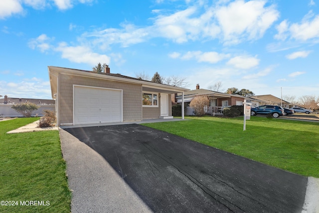 ranch-style house featuring a garage and a front yard