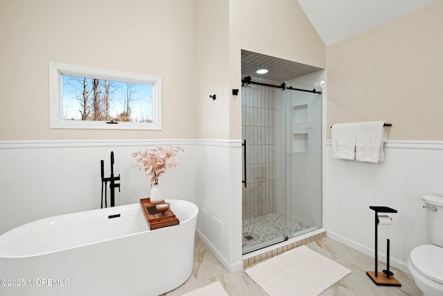 bathroom with separate shower and tub, toilet, and lofted ceiling