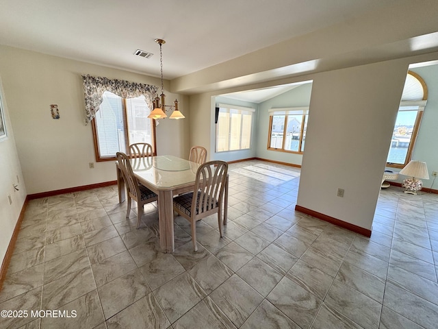 dining area with vaulted ceiling