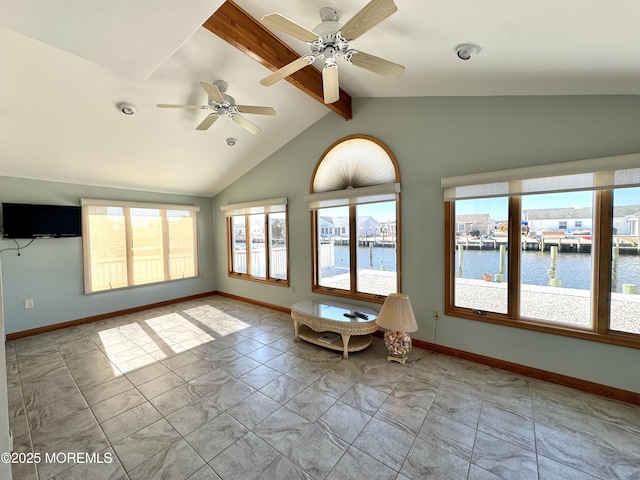 unfurnished sunroom with vaulted ceiling with beams and a water view