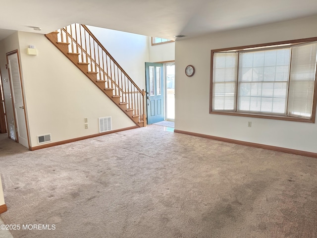 unfurnished living room featuring carpet