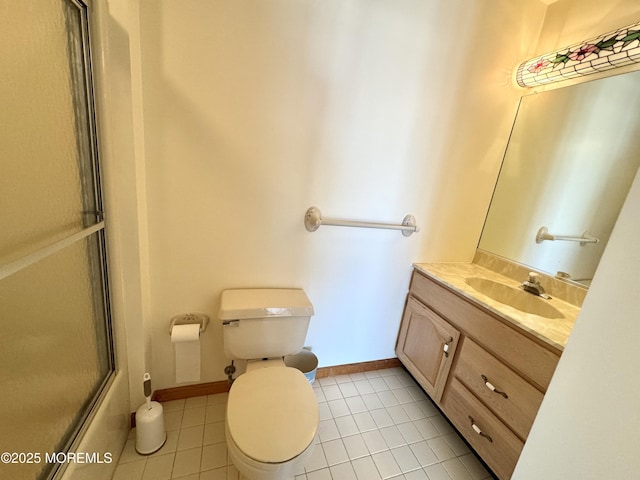 bathroom with tile patterned flooring, vanity, and toilet