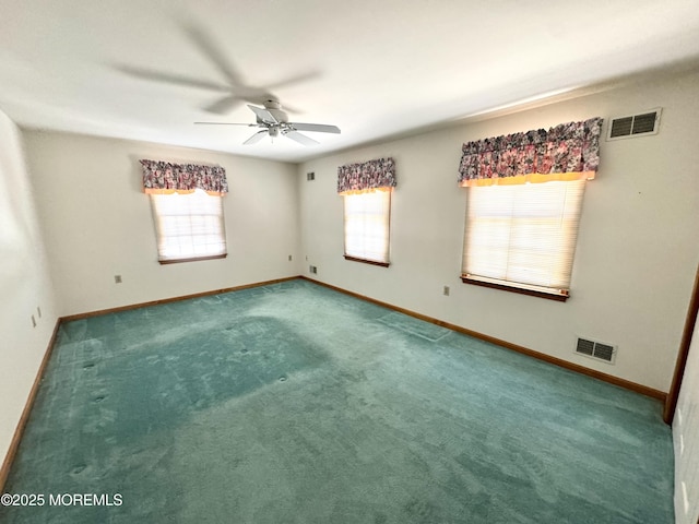 spare room featuring ceiling fan, carpet floors, and a healthy amount of sunlight