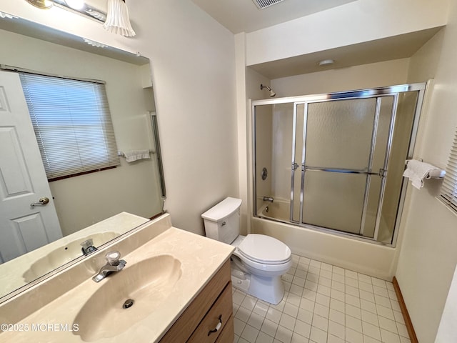 full bathroom featuring tile patterned flooring, enclosed tub / shower combo, vanity, and toilet