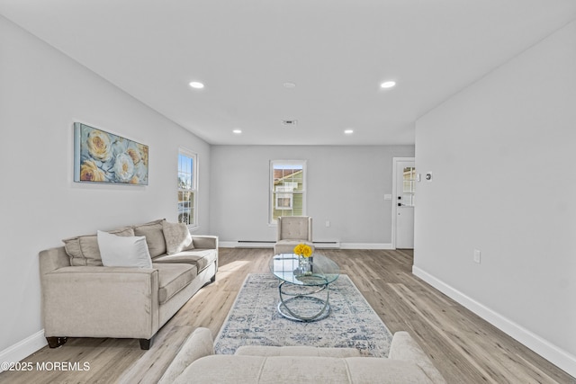 living area featuring recessed lighting, baseboards, and light wood finished floors